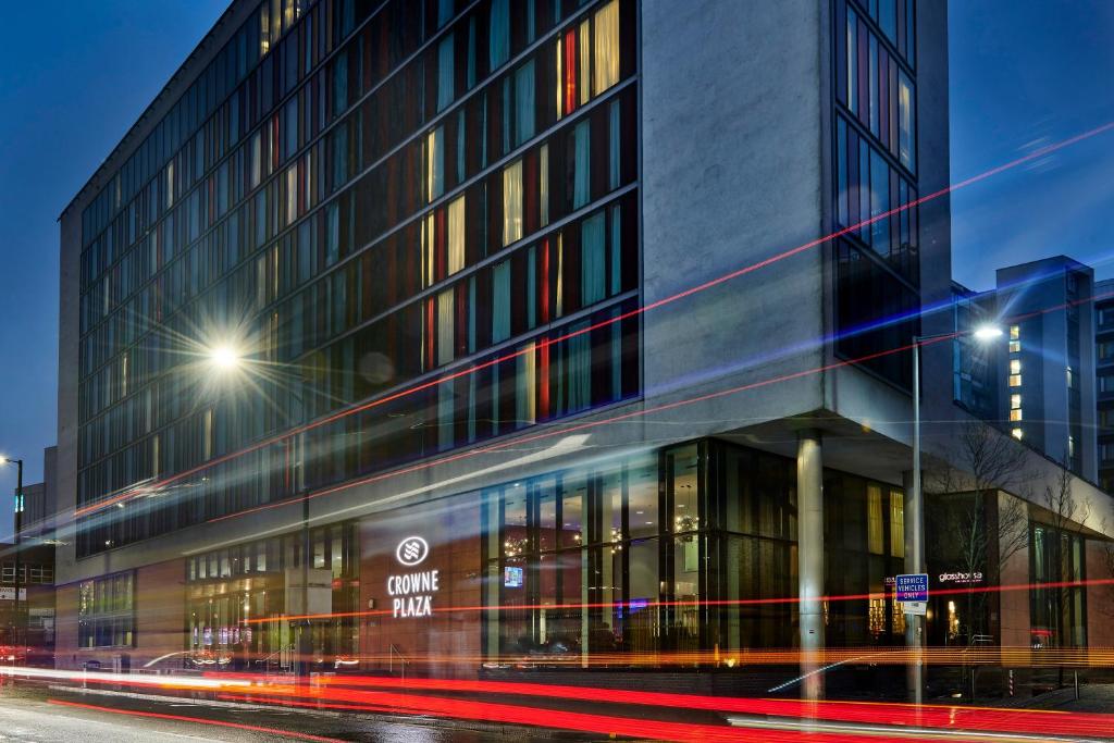 a building on a city street at night at Crowne Plaza Manchester City Centre, an IHG Hotel in Manchester