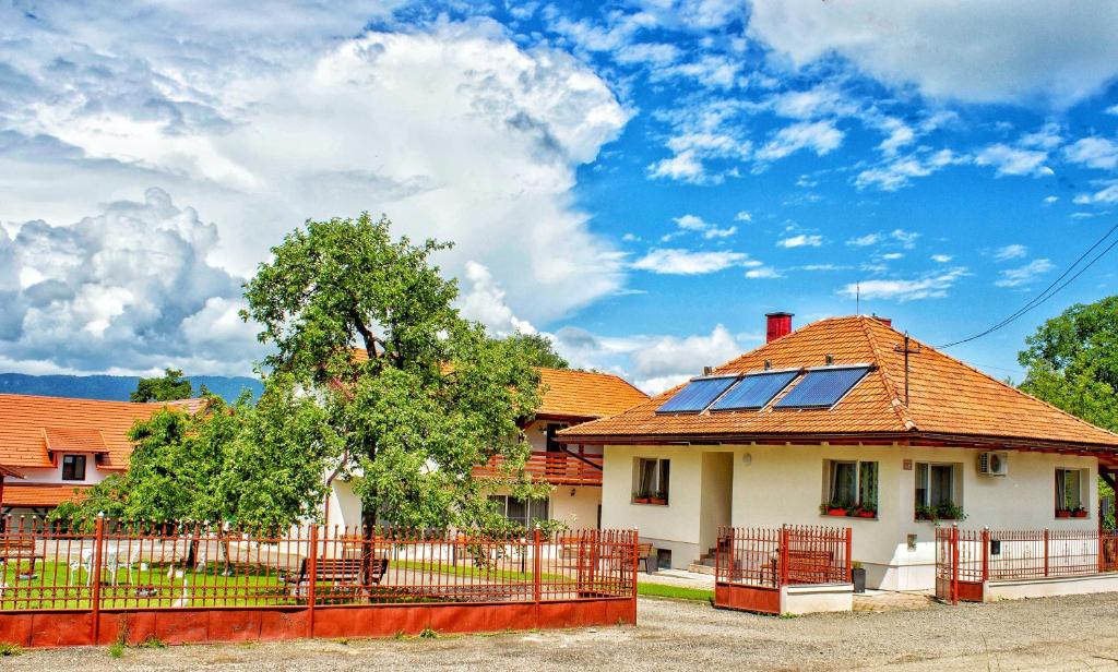 a house with solar panels on the roof at Pensiunea Mariana in Ocna Şugatag