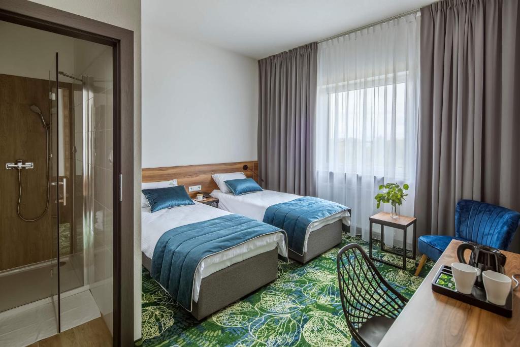 Una cama o camas en una habitación de Bloom Hotel Airport Okęcie