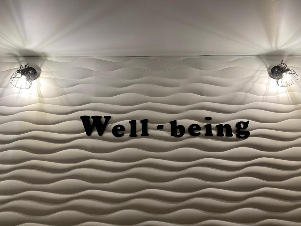 a room with two lights and a wall with the words well being at Апартаменты Well - Being in Umanʼ