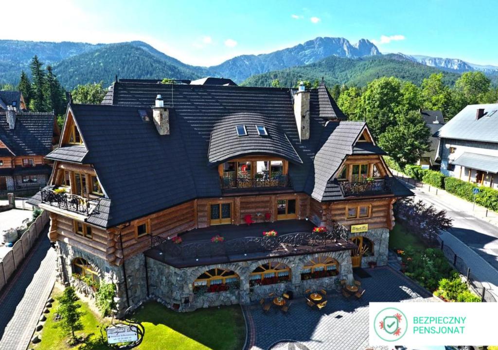 uma vista aérea de uma casa de madeira com montanhas ao fundo em Zakopiański Dwór em Zakopane