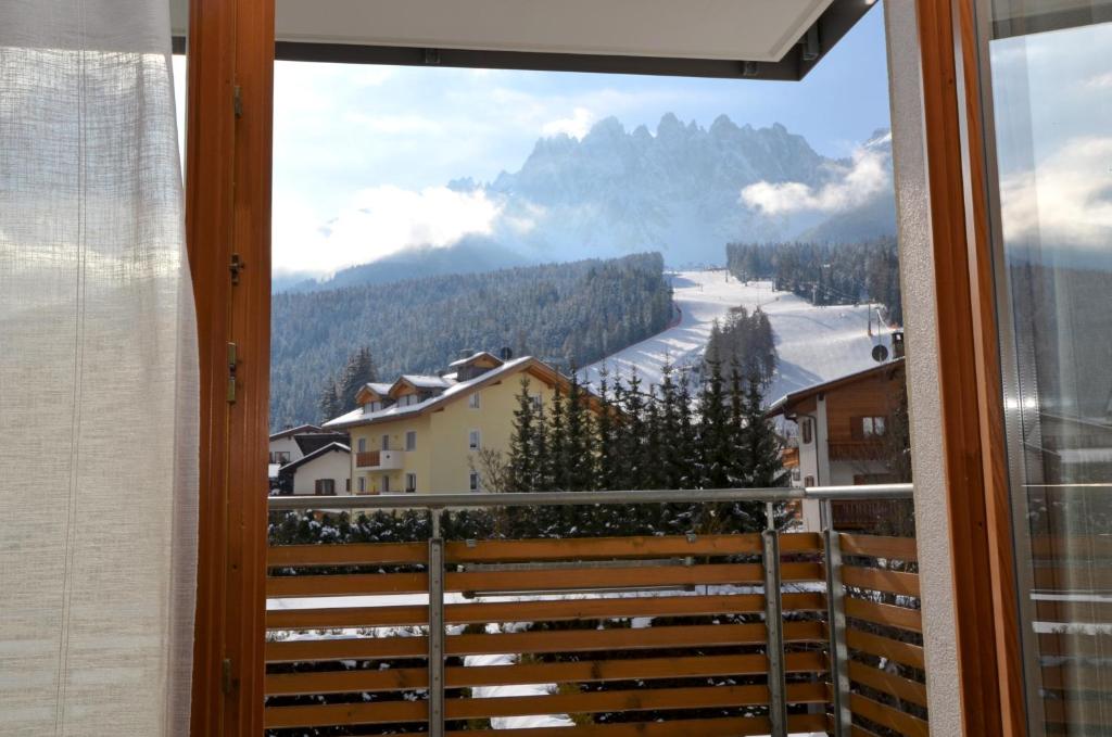 a window with a view of a snow covered mountain at Aurturist S Candido Roulette in San Candido