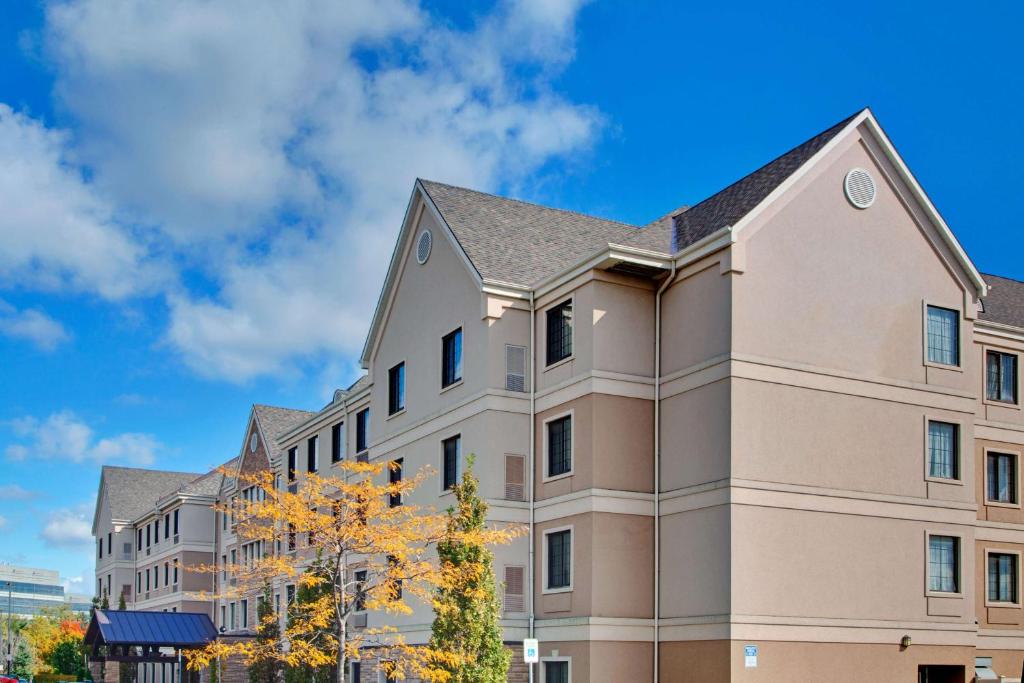 a building with a blue sky in the background at Sonesta ES Suites Toronto Markham in Markham