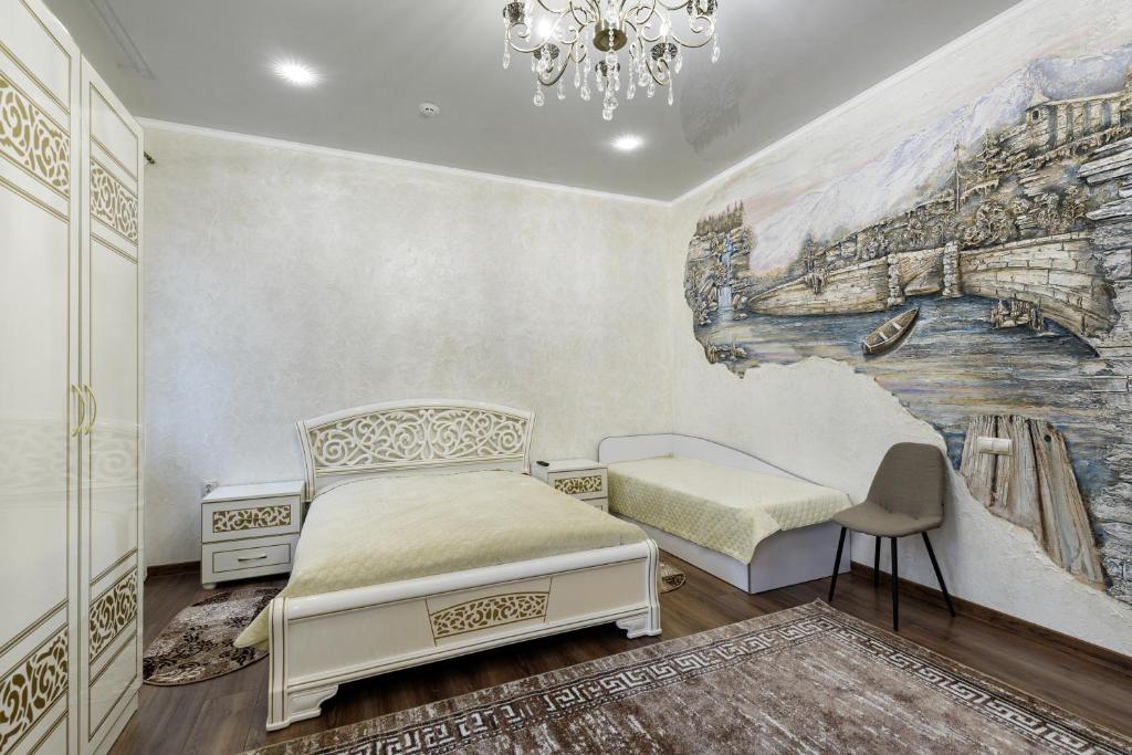 a bedroom with a bed and a painting on the wall at Апартаменти в Старому Місті Sweet House in Kamianets-Podilskyi