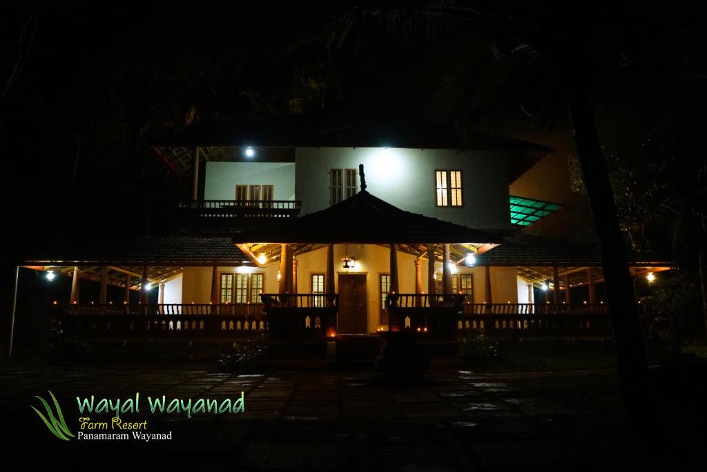 a night view of a house with lights at Wayal Wayanad Heritage villa in Panamaram