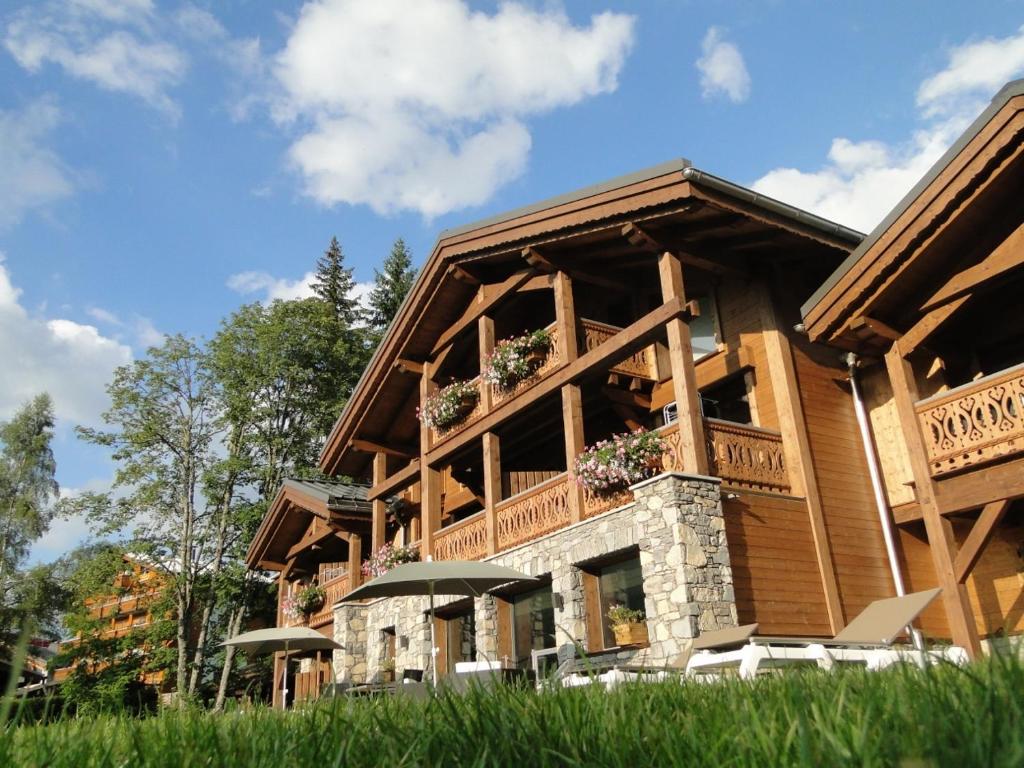 een groot huis met een balkon aan de zijkant bij Les Chalets d'Adelphine & SPA in Les Gets