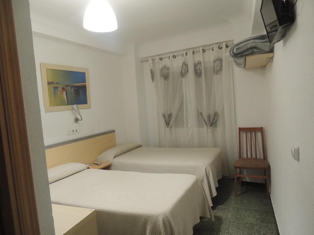 Una cama o camas en una habitación de Hostal Cumbre