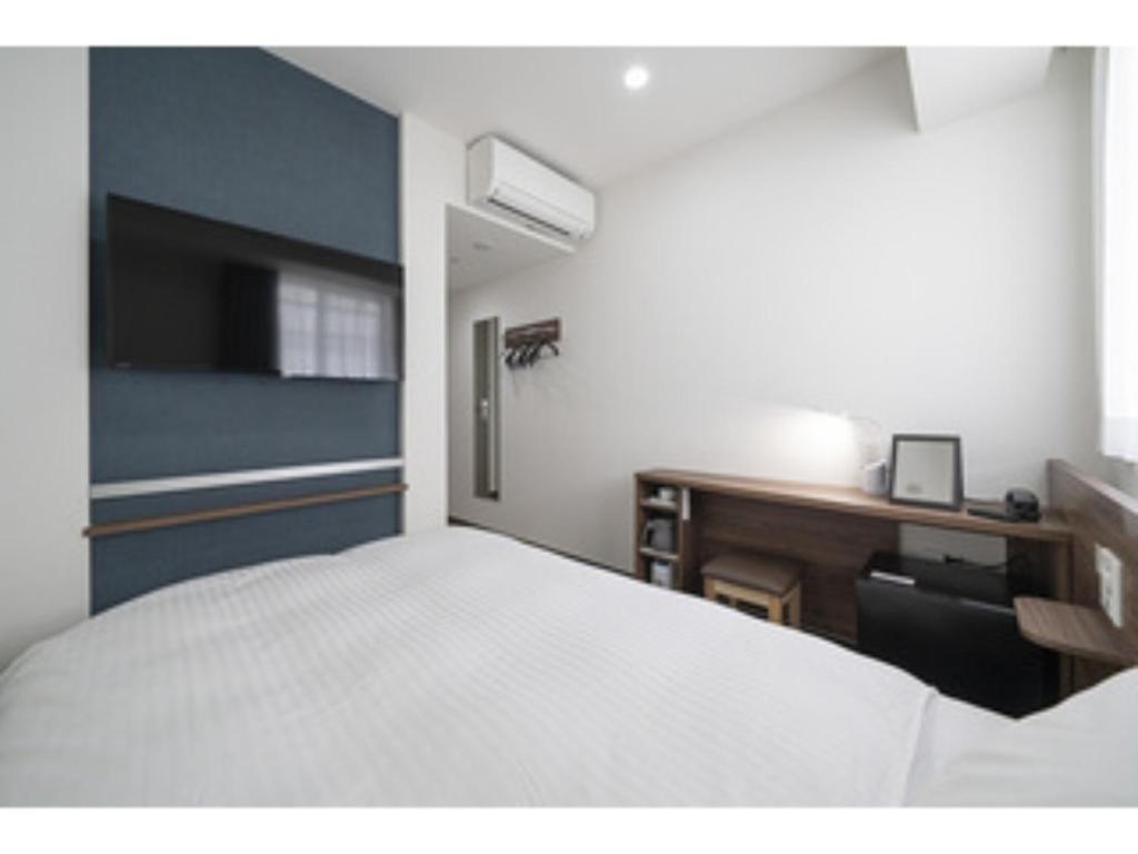 Tempat tidur dalam kamar di R&B Hotel Nagoya Ekimae - Vacation STAY 15184v