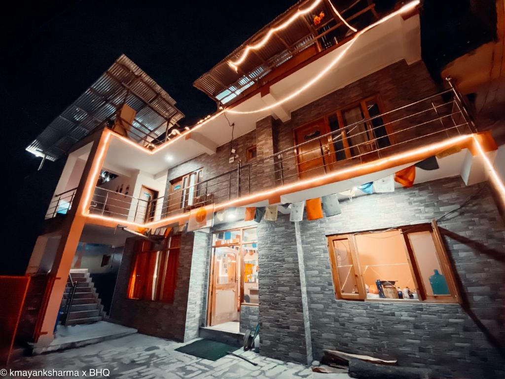 a building with a balcony with lights on it at Backpackers Headquarter Manali in Manāli