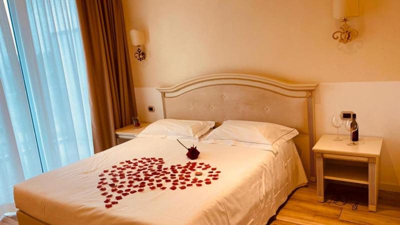 a bed with a heart made out of hearts on it at Palace Hotel & SPA La CONCHIGLIA D' ORO in Vicenza