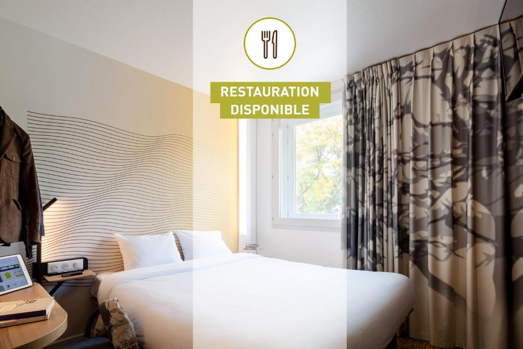 a hotel room with a bed and a window at B&B HOTEL Thionville Centre Gare Porte du Luxembourg A31 in Thionville