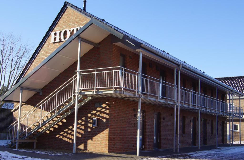 a building with stairs on the side of it at Hotel zur Erholung in Buxtehude