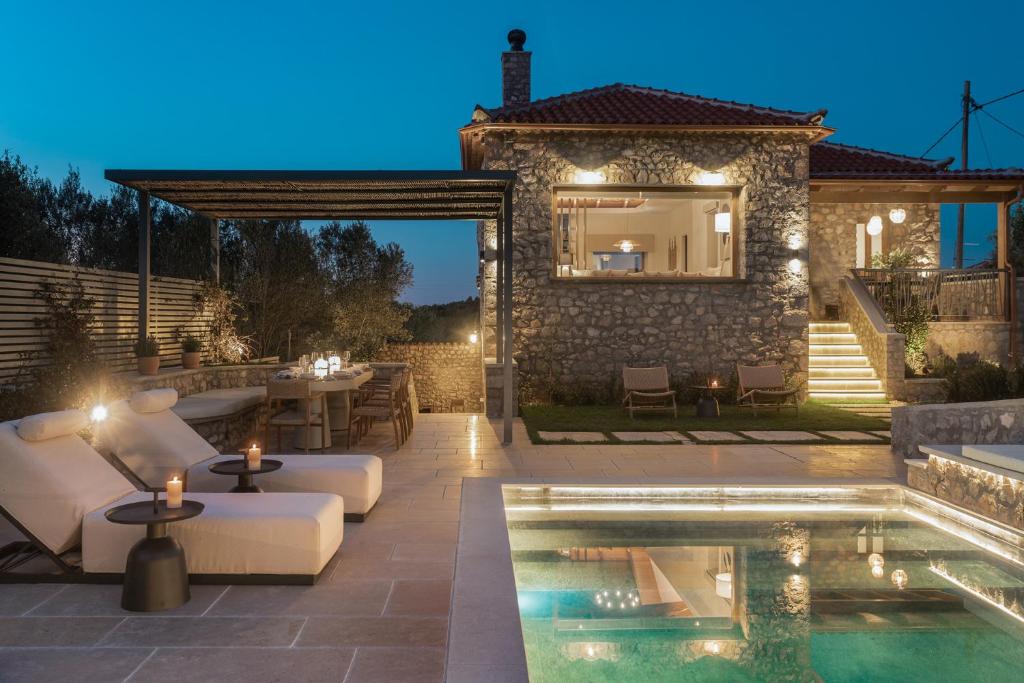 a backyard with a pool and a villa at OD Luxury Villa in Pylos