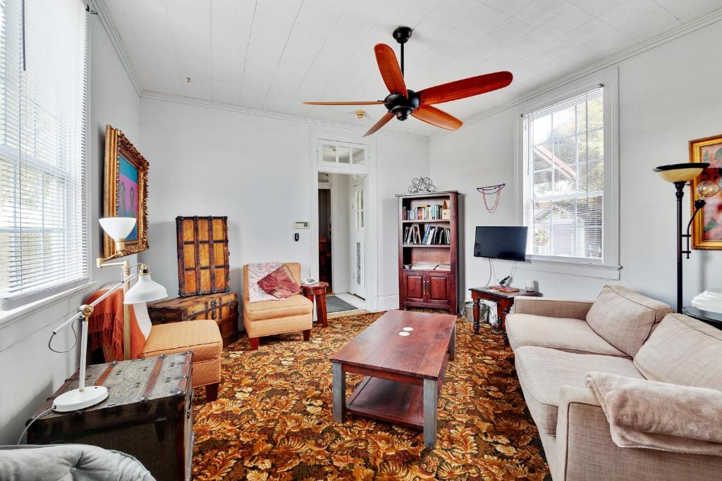 Bywater Home, Parking and Pet Friendly Retreat في نيو أورلينز: غرفة معيشة مع أريكة ومروحة سقف