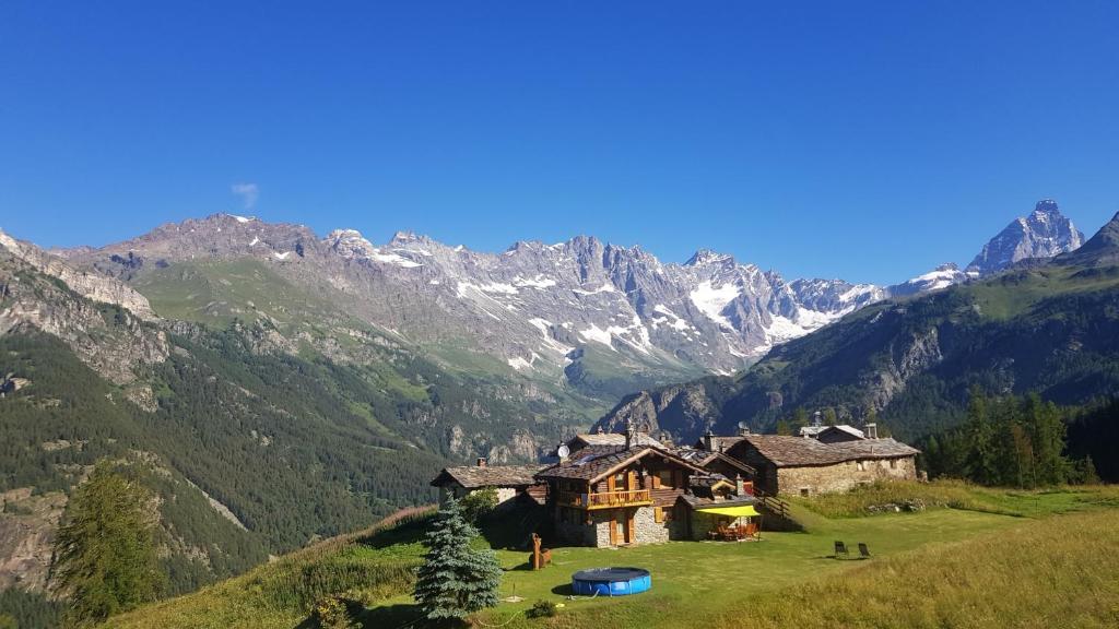 ヴァルトゥルナンシュにあるChalet Le Lisの山を背景にした丘の上の家