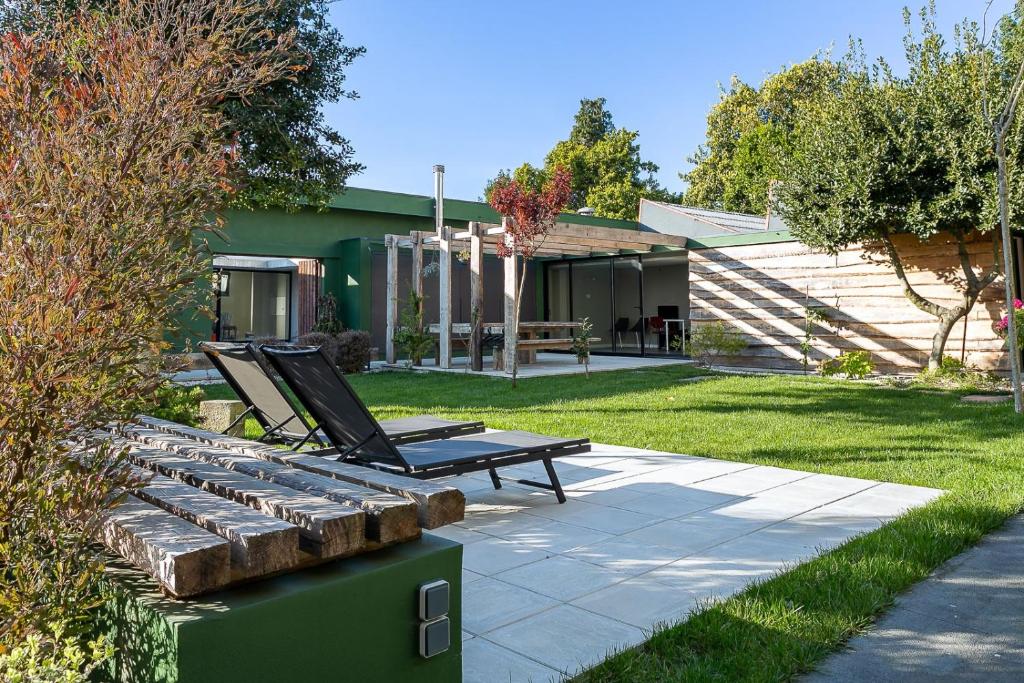 a patio with a chaise lounger and a bench at Pateo 780 in Vila Nova de Gaia