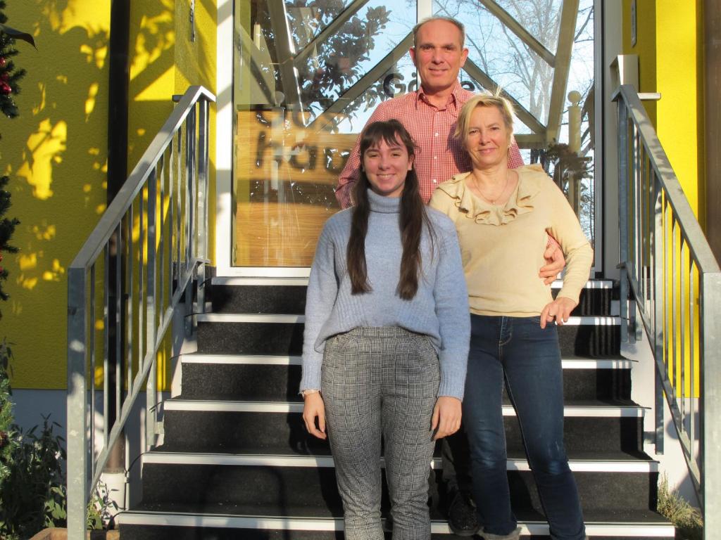 Ein Mann und zwei Frauen stehen auf der Treppe in der Unterkunft Gästehaus Wagner in Bad Krozingen