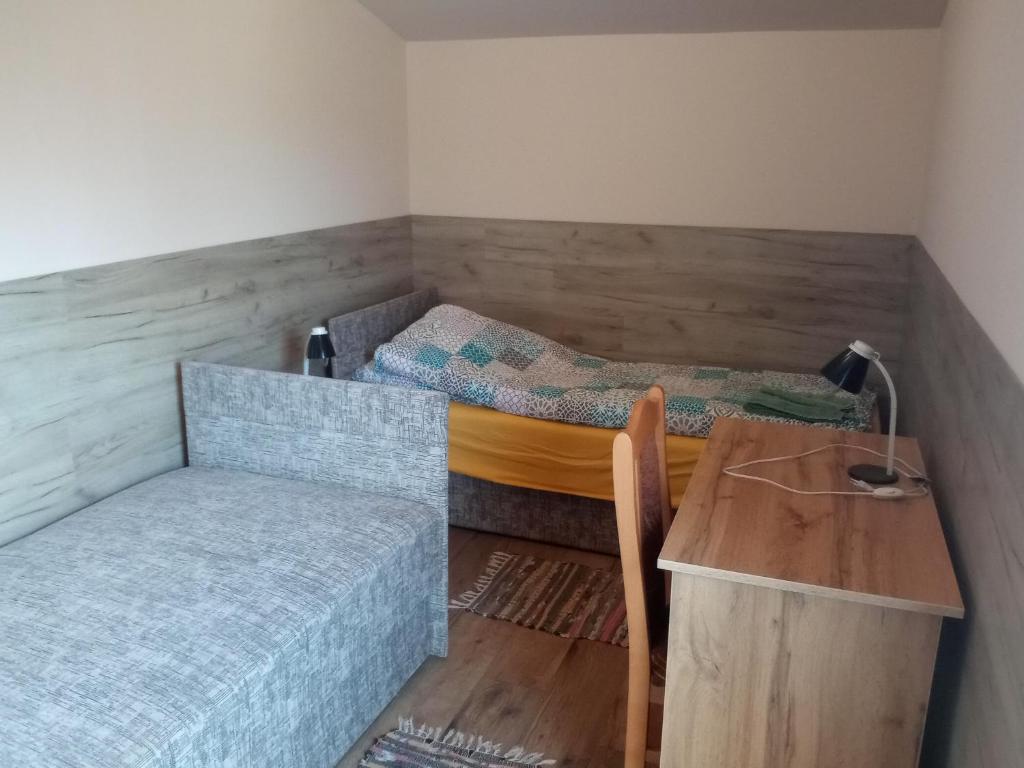 Budai Vám Apartmanház في بيتْش: غرفة بسريرين ومكتب وطاولة