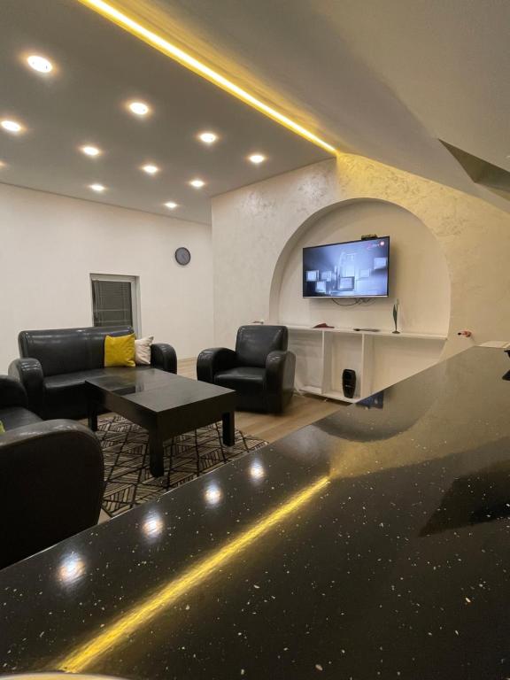 sala de estar con sofás y TV de pantalla plana. en LUNA Apartment, en Novi Pazar