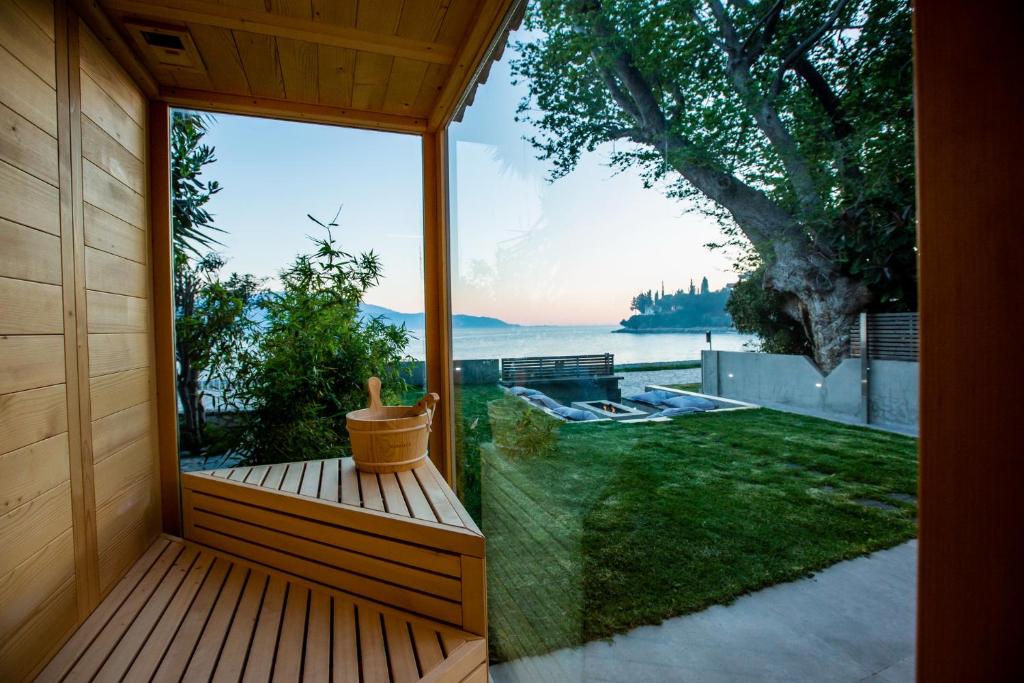 a wooden porch with a view of the water at Spa Villa Skaloma in Nafpaktos