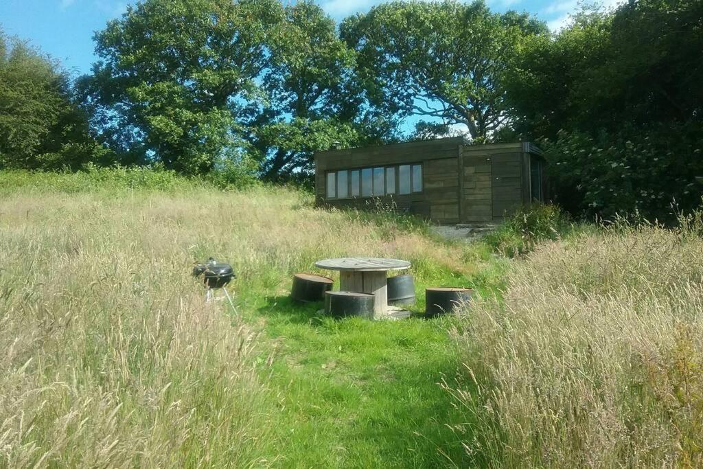 einen Picknicktisch in der Mitte eines Feldes in der Unterkunft Stags View,Unique eco cabin, Dartmoor views in South Brent