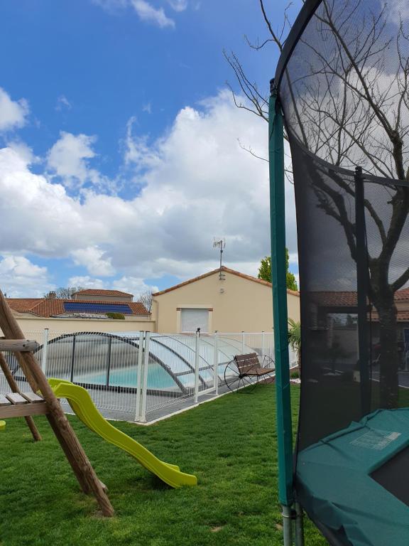 un parco giochi con scivolo in un cortile di Chez les J-FOLAIS - 3 kms Puy duFou - Les Epesses a Les Épesses