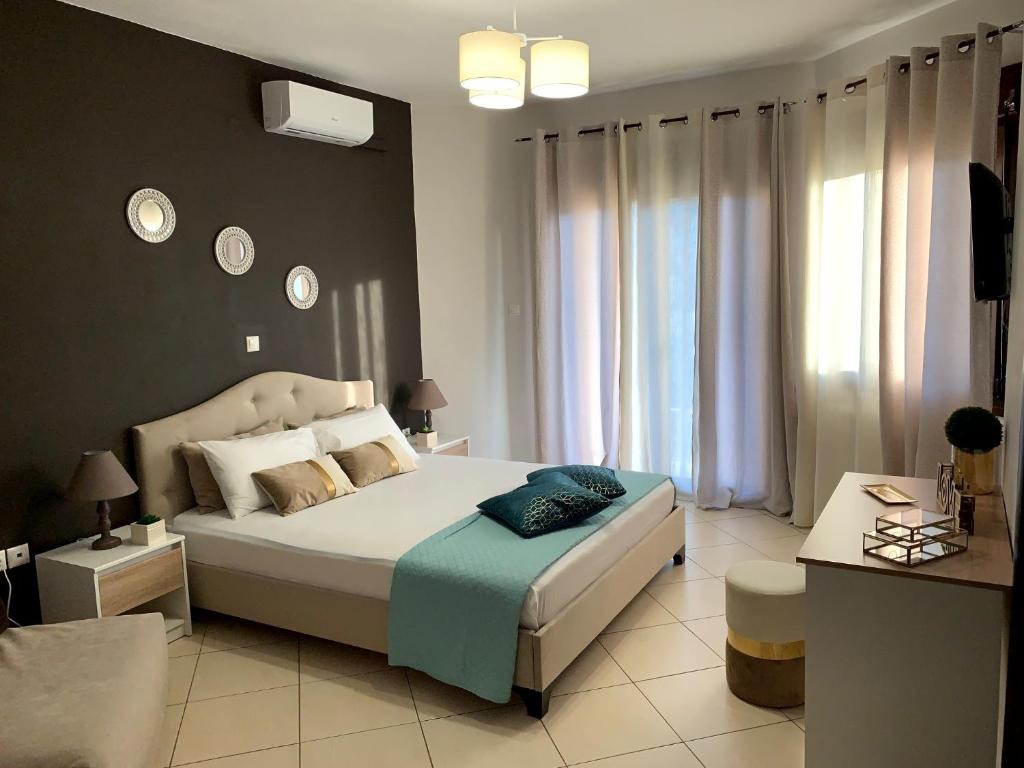 A bed or beds in a room at Moschoula Villa - Sea View Grand Apartment