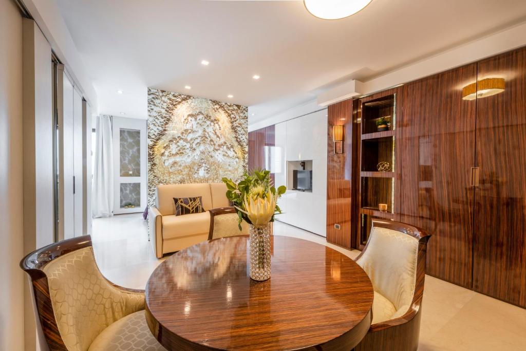 a dining room with a wooden table and chairs at Milan Royal Suites - Centro in Milan