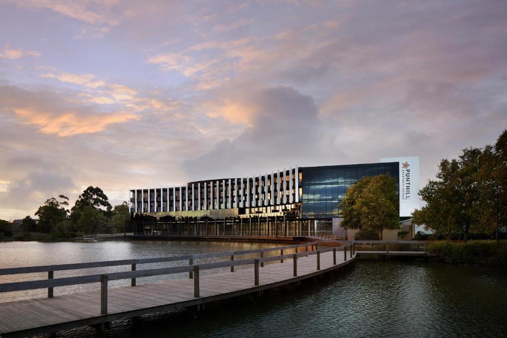 a large building next to a body of water at Punthill Caroline Springs in Caroline Springs