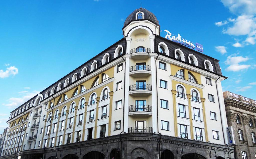 a building with a clock tower on top of it at Radisson Blu Hotel, Kyiv Podil City Centre in Kyiv