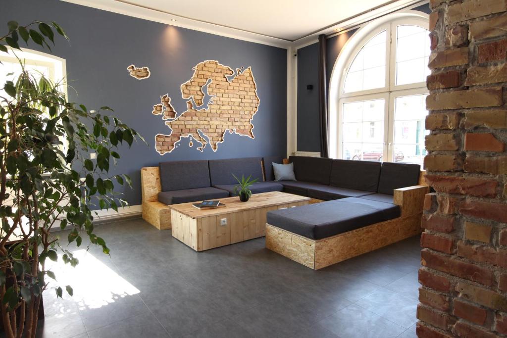 a living room with a couch and a coffee table at Blue Doors Hostel KTV in Rostock