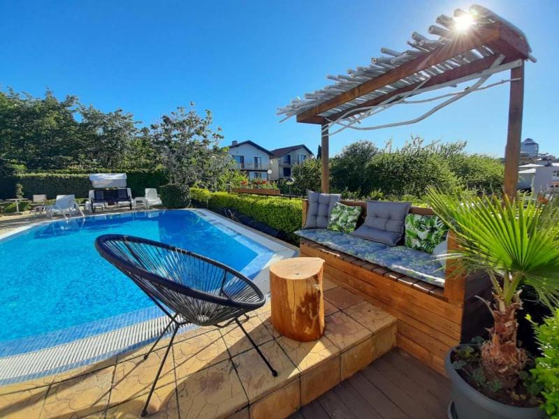 uma piscina com uma cadeira ao lado de um pátio em Milennia Family Hotel em Sunny Beach