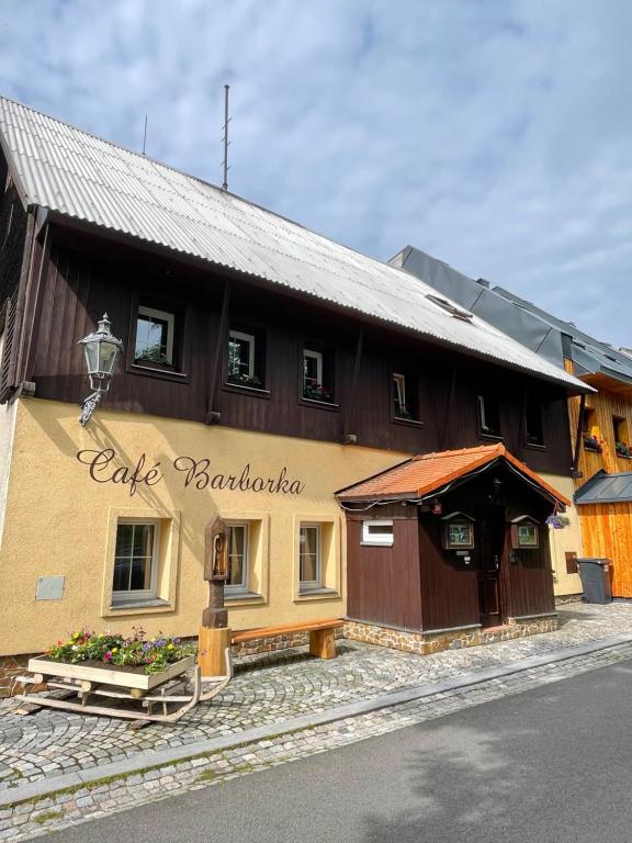 a building with a sign on the side of it at Pension Barborka in Boží Dar