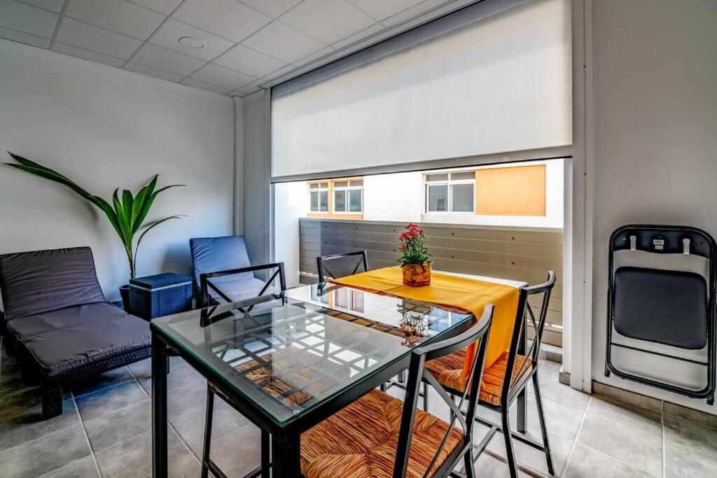 a dining room with a glass table and chairs at Loft Life 3 in Arrecife