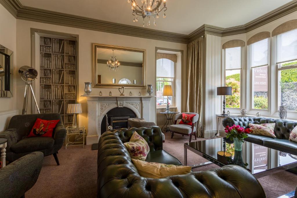 a living room with a couch and a fireplace at Jerichos Boutique Accommodation in Windermere