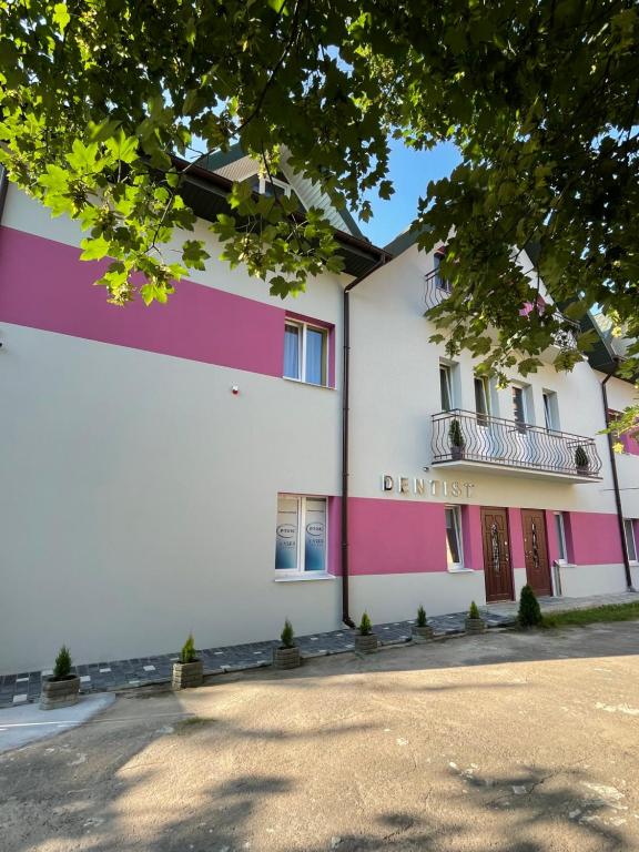 a building with pink and purple stripes at Apart-Hotel у центрі Трускавця in Truskavets