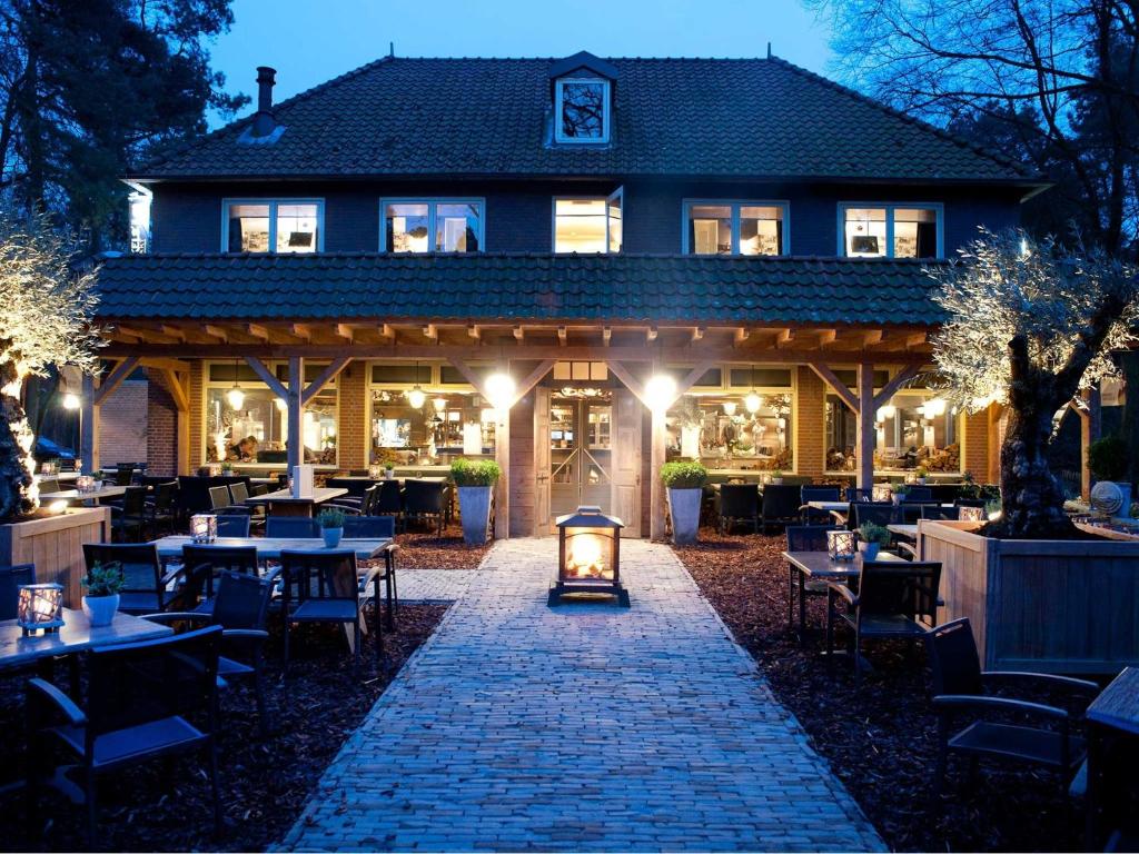 un restaurant avec une passerelle en briques devant un bâtiment dans l'établissement Hotel & Restaurant Meneer Van Eijck, à Oisterwijk