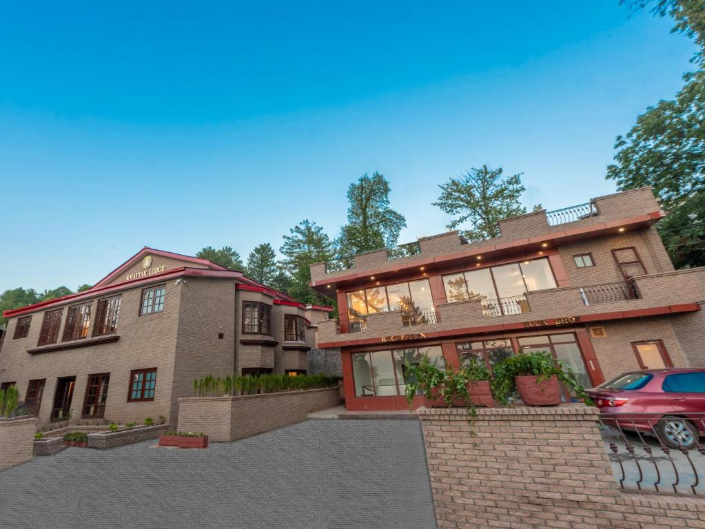 a house with a car parked in front of it at Khattak Lodge Murree in Murree