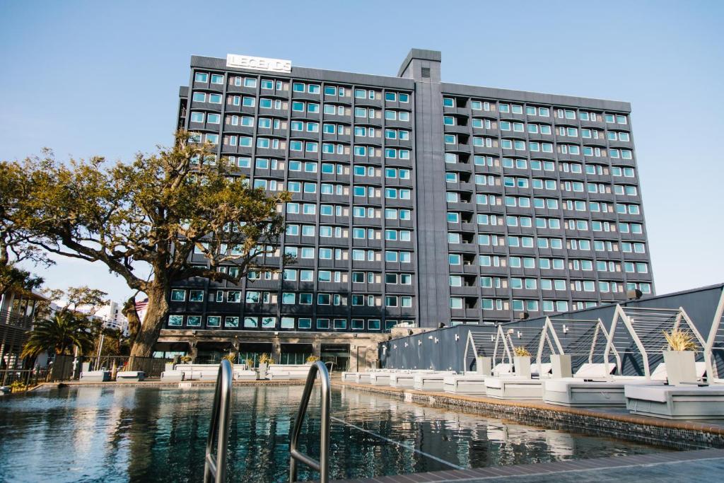 a building with a pool of water in front of a building at Hotel Legends in Biloxi