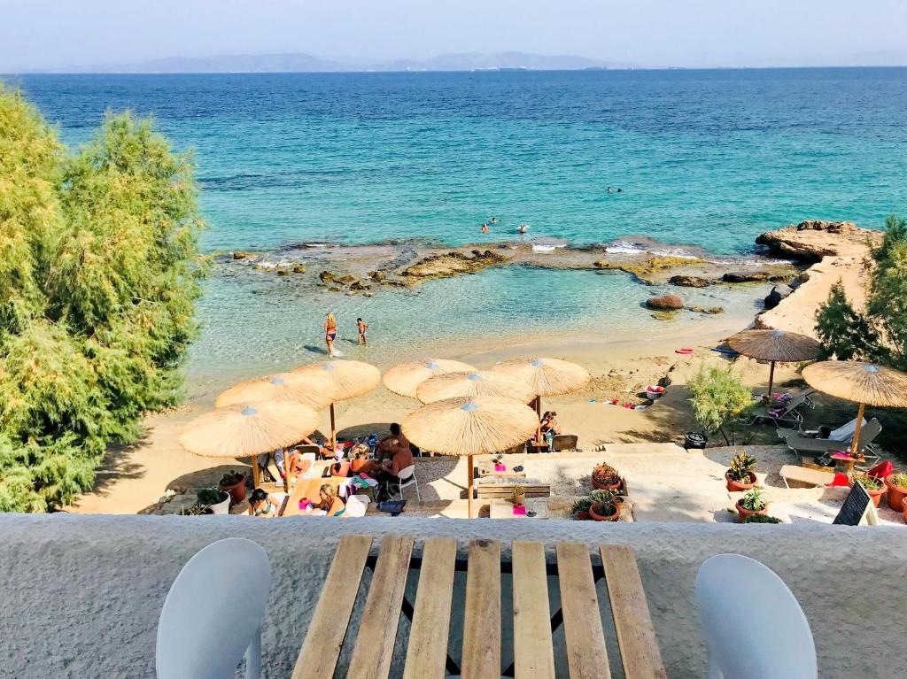 a view of a beach with umbrellas and people at The Beachhouse Apartments in Vaia