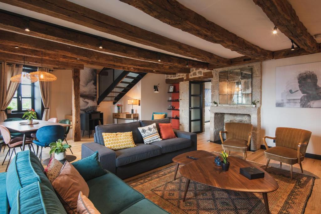 Cosy family nest in the medieval town في دينان: غرفة معيشة مع أريكة وطاولة