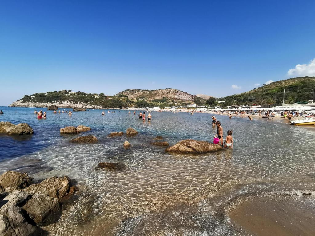 a group of people in the water at a beach at Acquamarina in Gaeta