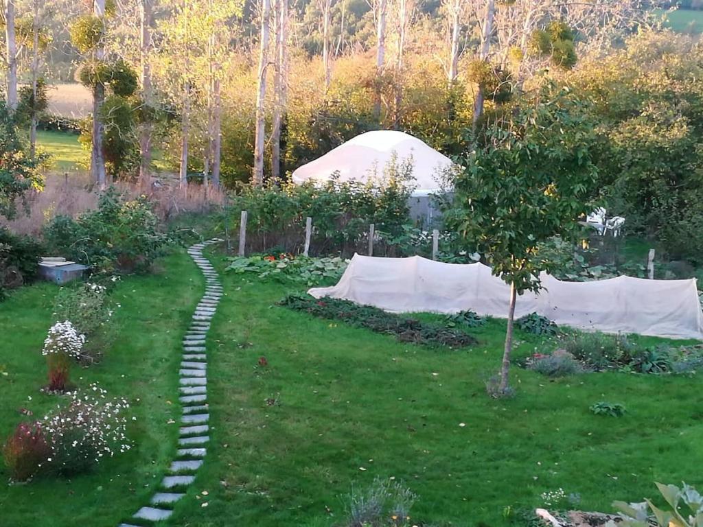 ogród z kamienną ścieżką w trawie w obiekcie La yourte au fonds du jardin w mieście Xhoris