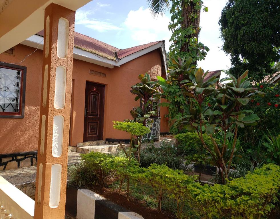 uma casa com um jardim em frente em Gorilla African Guest House em Entebbe