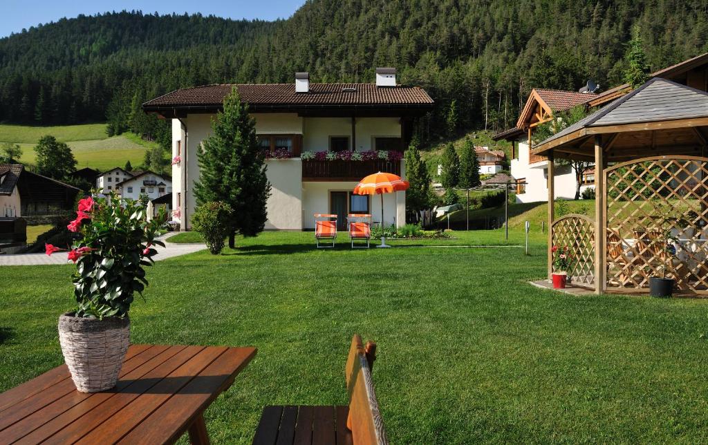 a house with a potted plant on a yard at Apartment Suliva in Santa Cristina in Val Gardena