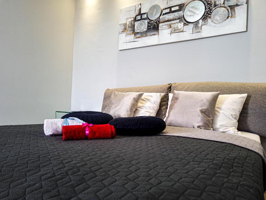 a bedroom with a bed with pillows on it at Apartment Apex penthouse self check-in in Karlovac