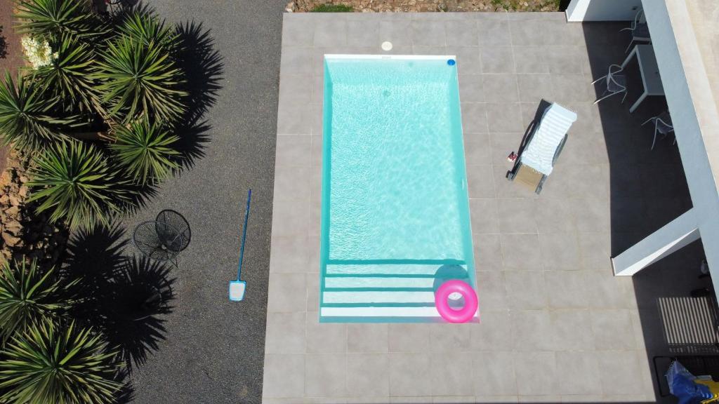 una vista sul tetto di una piscina con una persona accanto ad essa di Villa Montaña Colorada a Lajares