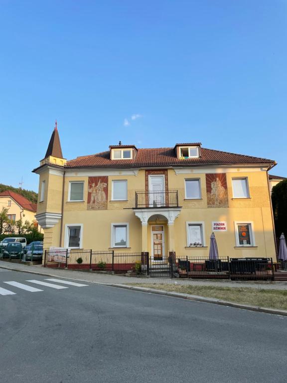 a yellow building on the side of a street at Penzion Ječmínek in Luhačovice