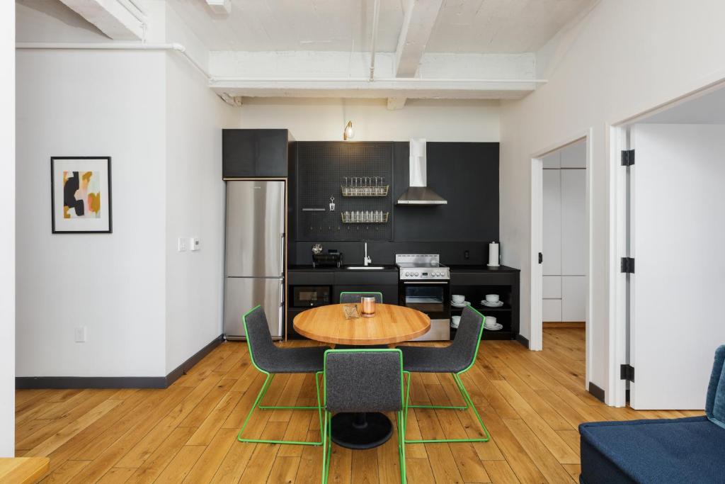 a kitchen with a table and chairs in a room at Placemakr Wall Street in New York