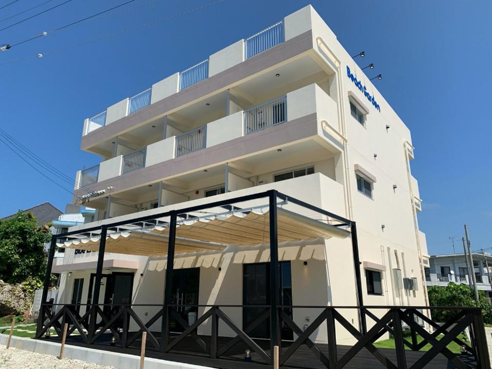 a large white building with a large balcony at Blue Entrance in Onna